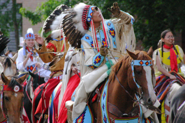 Indigenous People participate in the Calgary Stampede Parade, one of Canada's greatest summer festivals in 2024. 