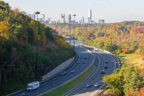 Commuters are driving in Canada along the Don Valley Parkway in Toronto on a fall day. 