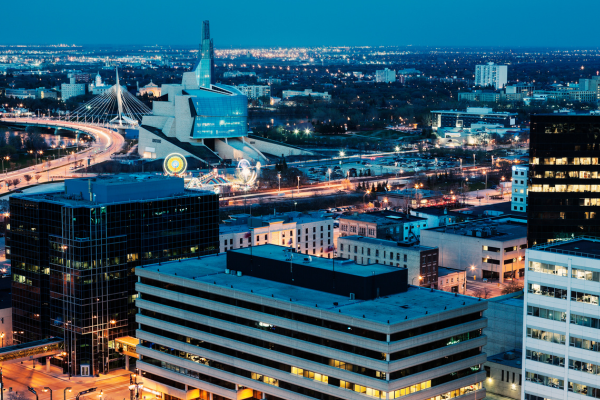 Building in downtown Winnipeg are illuminated at night. Canada latest housing market report shows home prices are up in Winnipeg