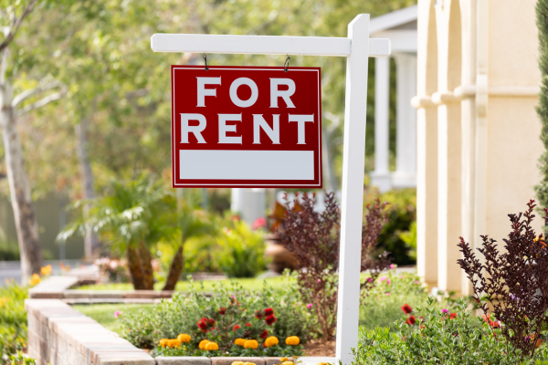 A for rent price sign hangs in front of a rental property. Rental prices are affecting inflation in Canada.